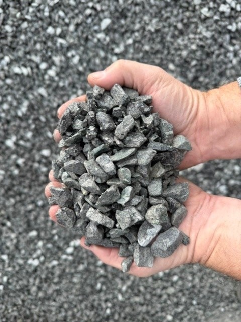 Two hands holding 5/8" clean crushed rock