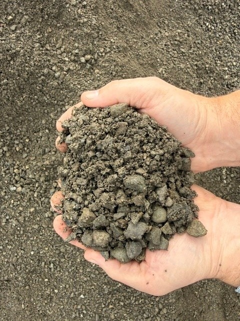 Two hands holding 5/8" minus recycle