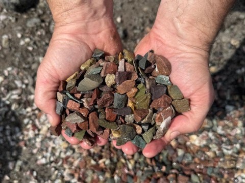 Two hands holding Montana rainbow crushed clean chip